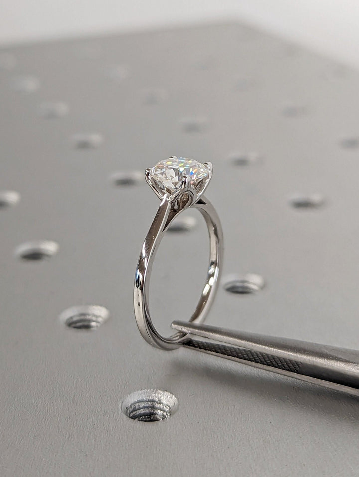 Round cut engagement ring side view showing band detail