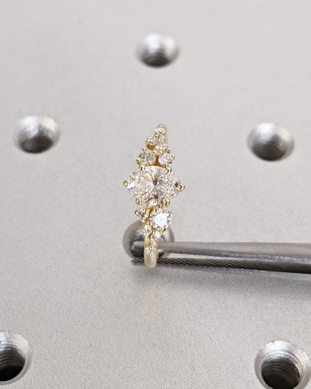 Certified oval cut diamond featured in cluster engagement ring