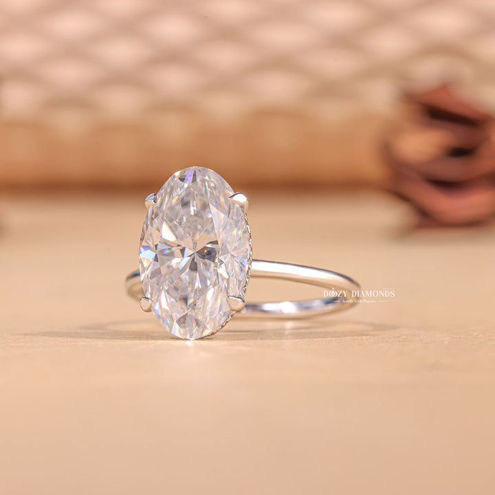 Detailed close-up of oval hidden halo diamond engagement ring