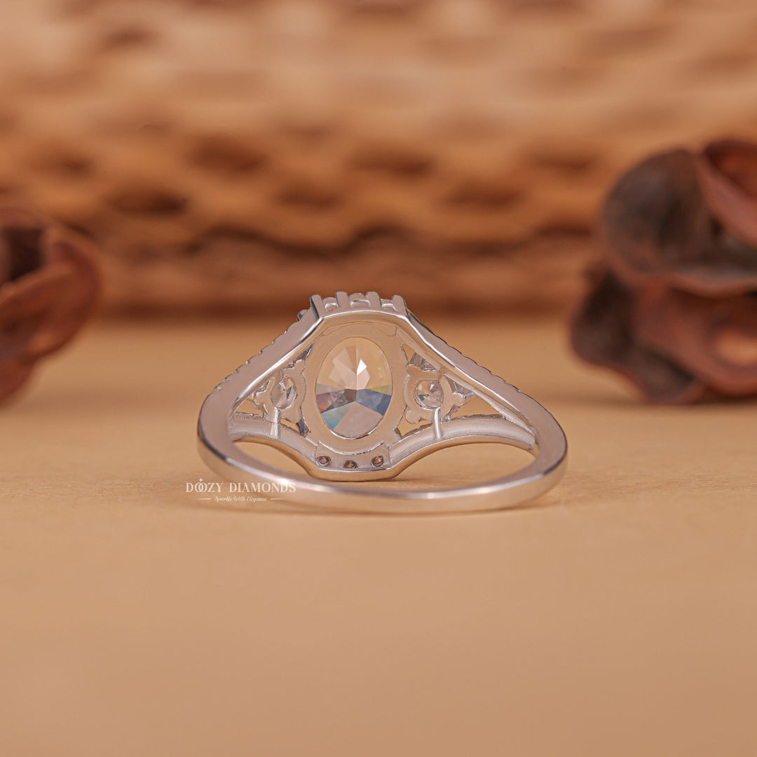 Close-up of oval cut center diamond in three stone engagement ring