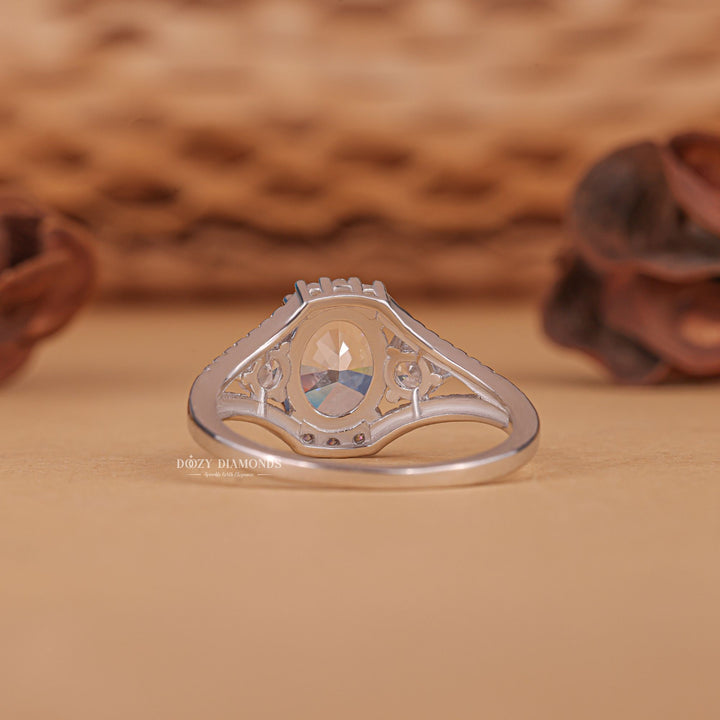 Close-up of oval cut center diamond in three stone engagement ring