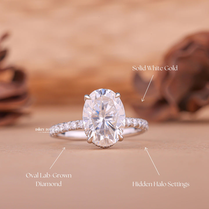 Oval hidden halo engagement ring photographed in natural light