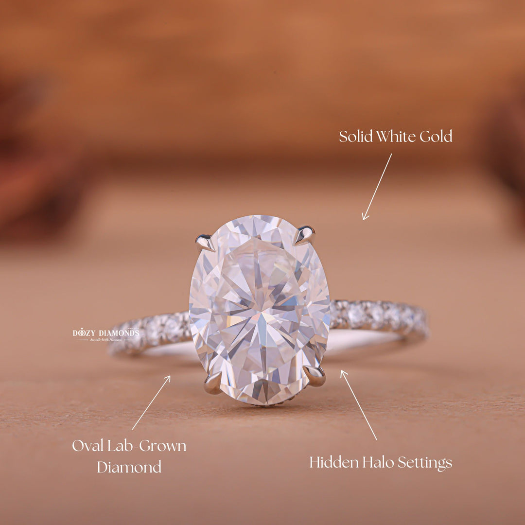 Oval hidden halo engagement ring photographed in natural light