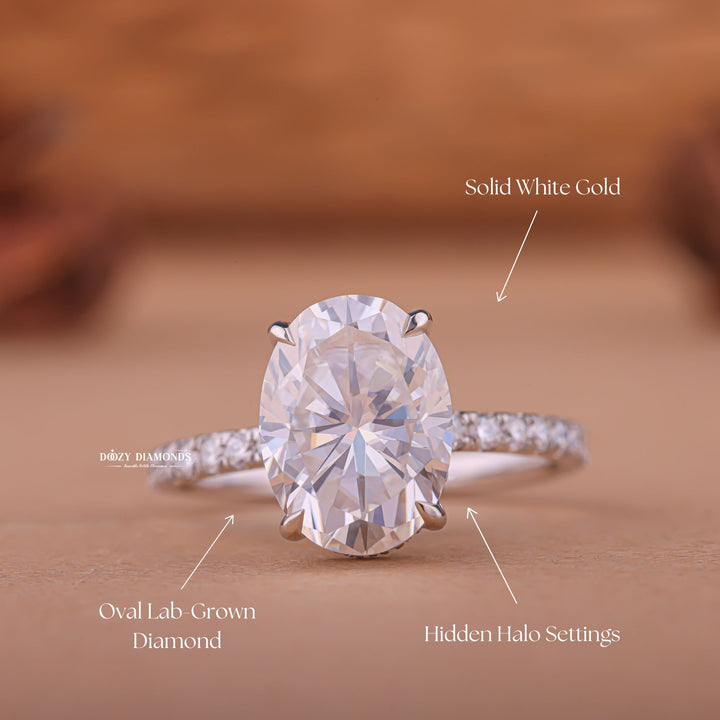 Oval hidden halo engagement ring photographed in natural light