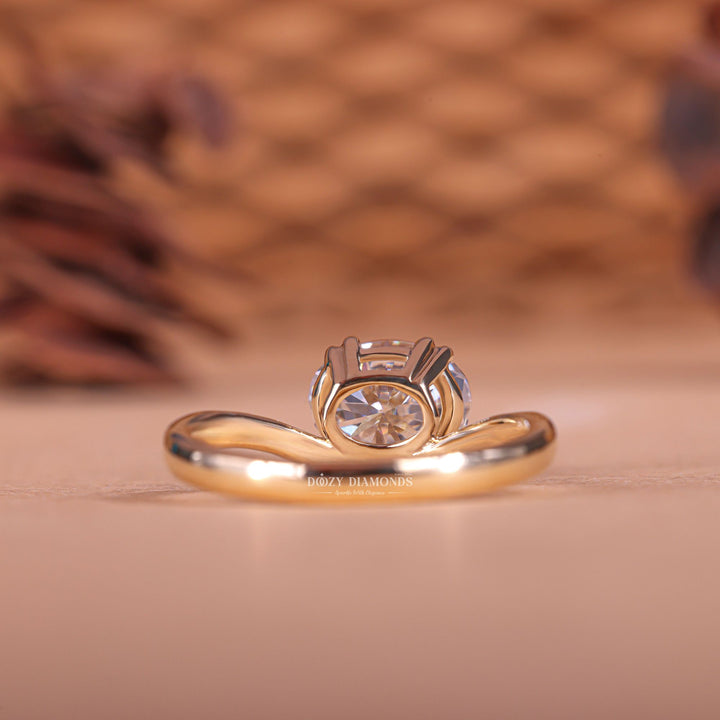 Oval east west diamond ring displayed on jewelry stand