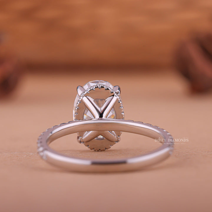 Fine craftsmanship detail on oval hidden halo engagement ring
