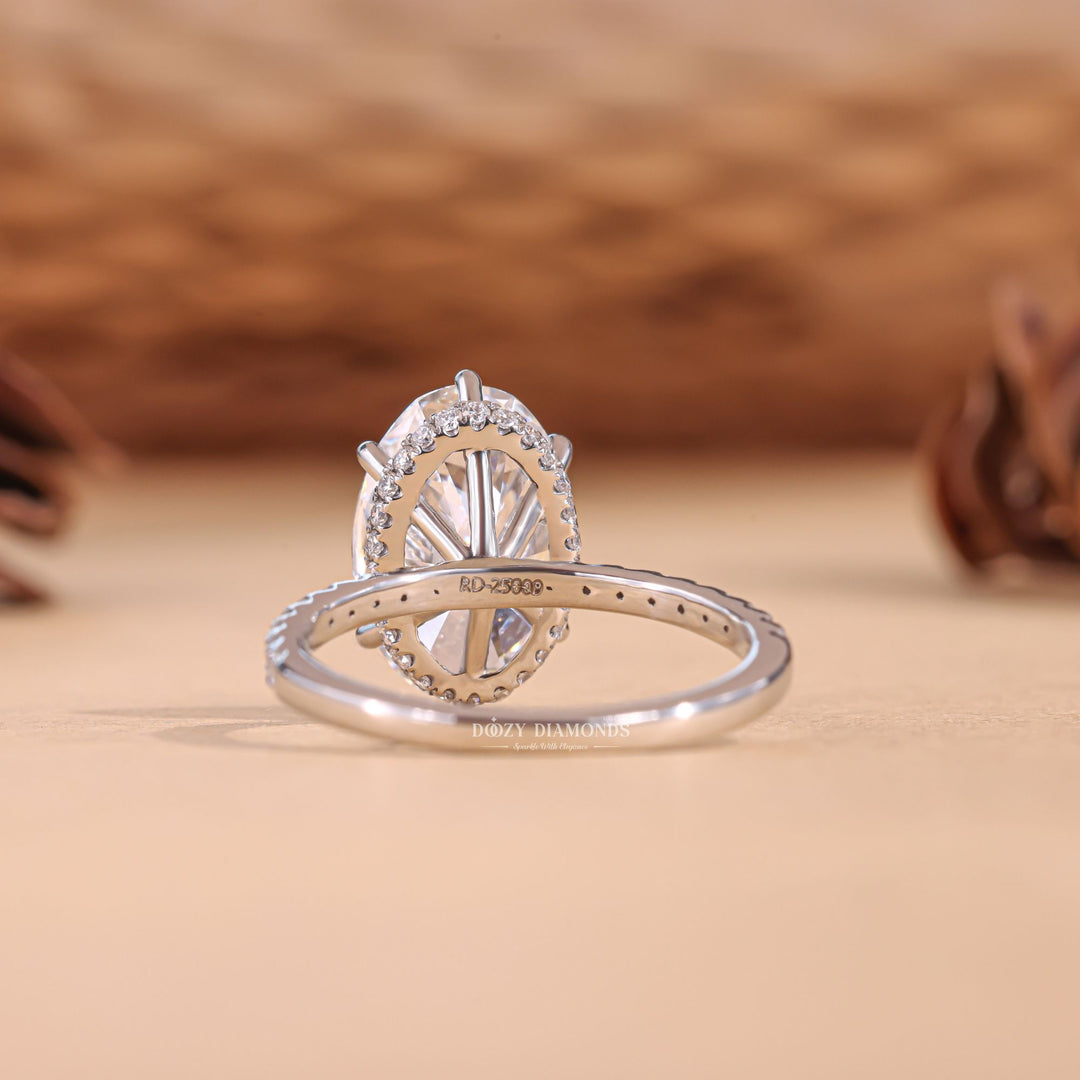 Close-up of oval cut center diamond in hidden halo engagement ring