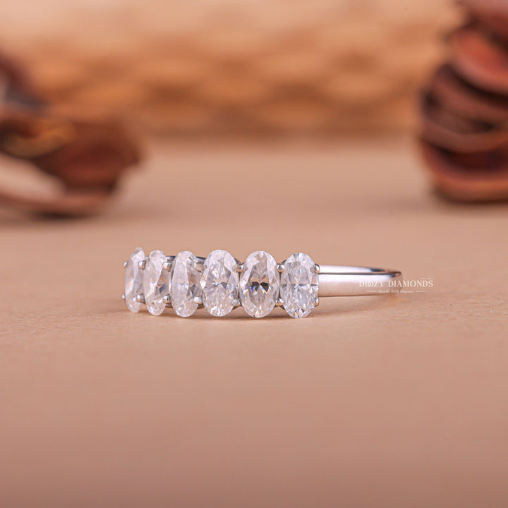 Oval diamond band stacked with engagement ring