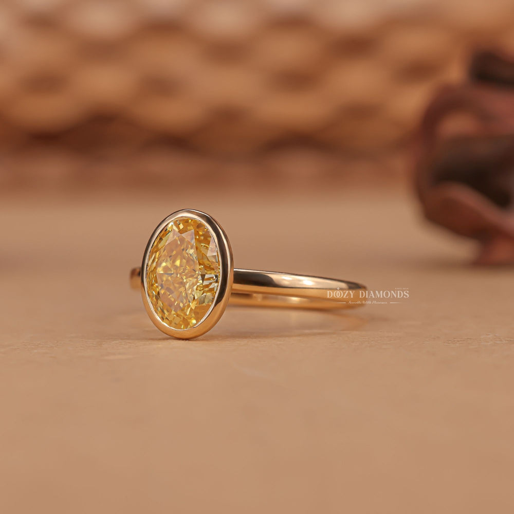 Oval bezel engagement ring shown on hand for true-to-life sizing