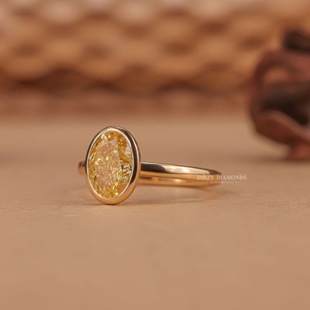 Oval bezel engagement ring shown on hand for true-to-life sizing