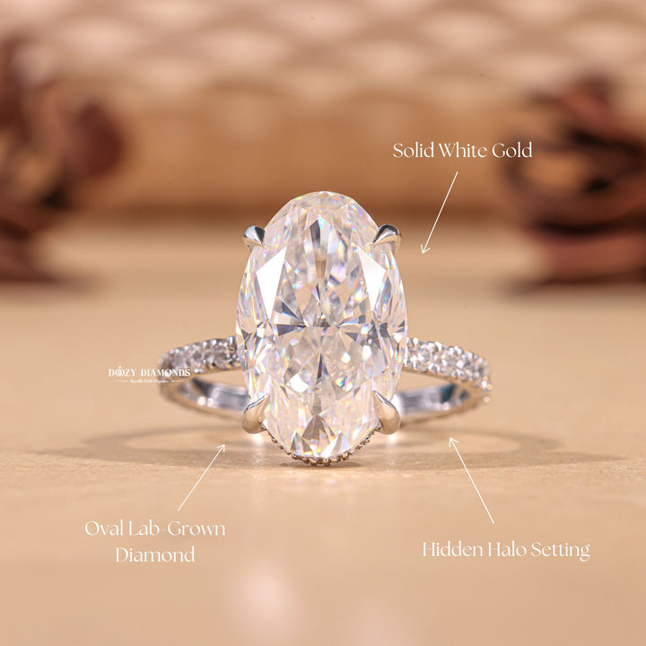 Oval hidden halo engagement ring photographed in natural light