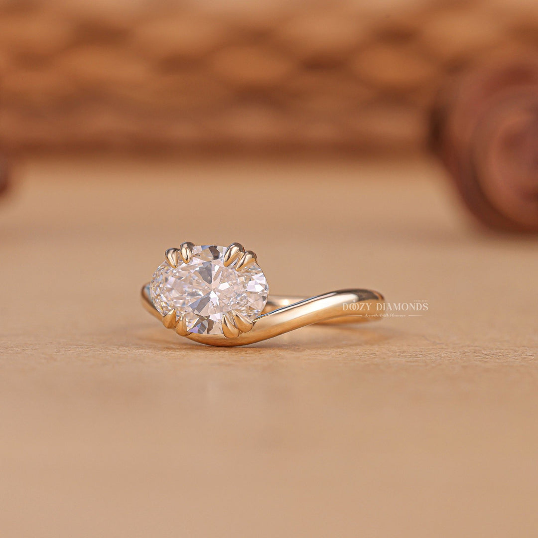 Oval solitaire engagement ring shown on hand for true-to-life sizing