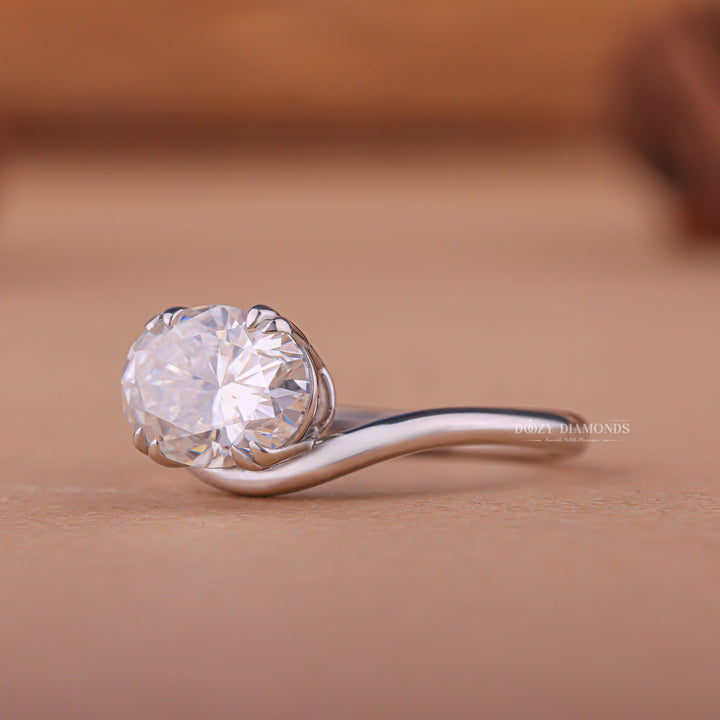 Side angle of oval east west diamond engagement ring