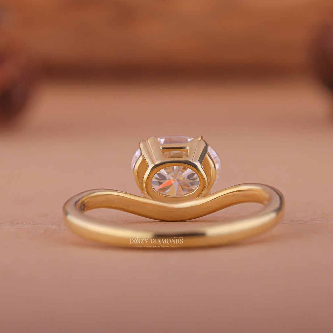 Close-up of oval cut center diamond in east west engagement ring