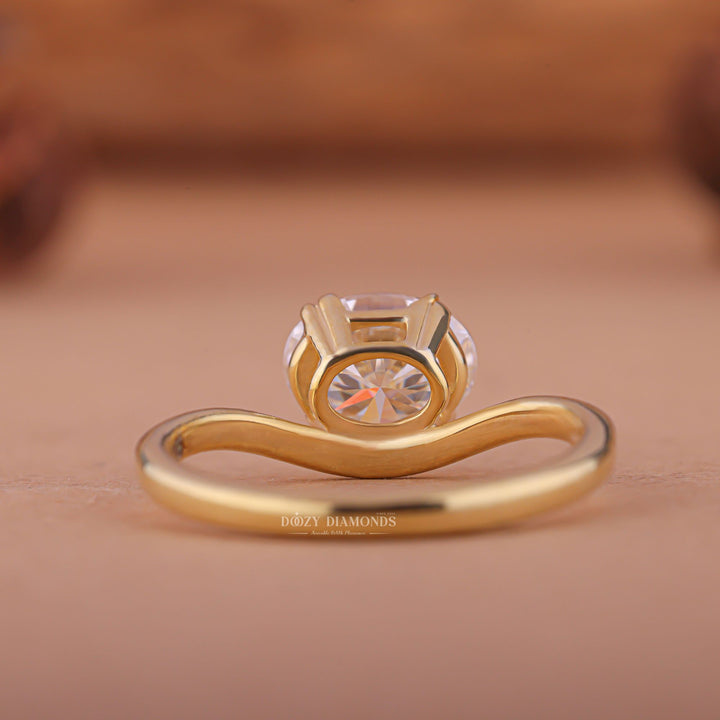 Close-up of oval cut center diamond in east west engagement ring