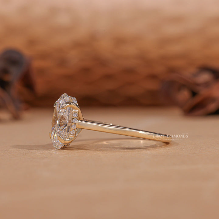 Detailed close-up of oval hidden halo diamond engagement ring