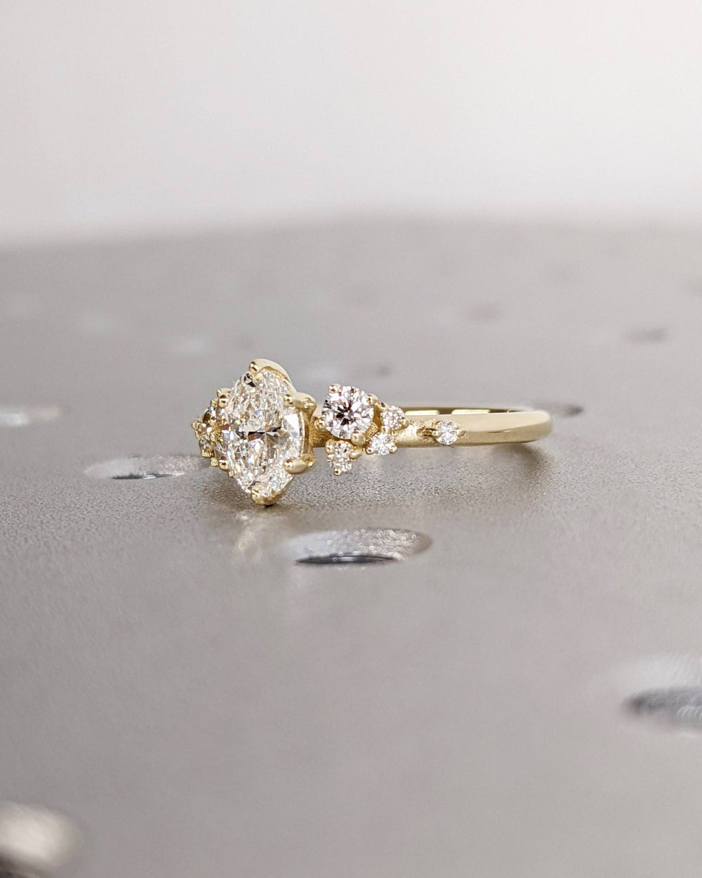 Oval cut cluster engagement ring with IGI certified center diamond