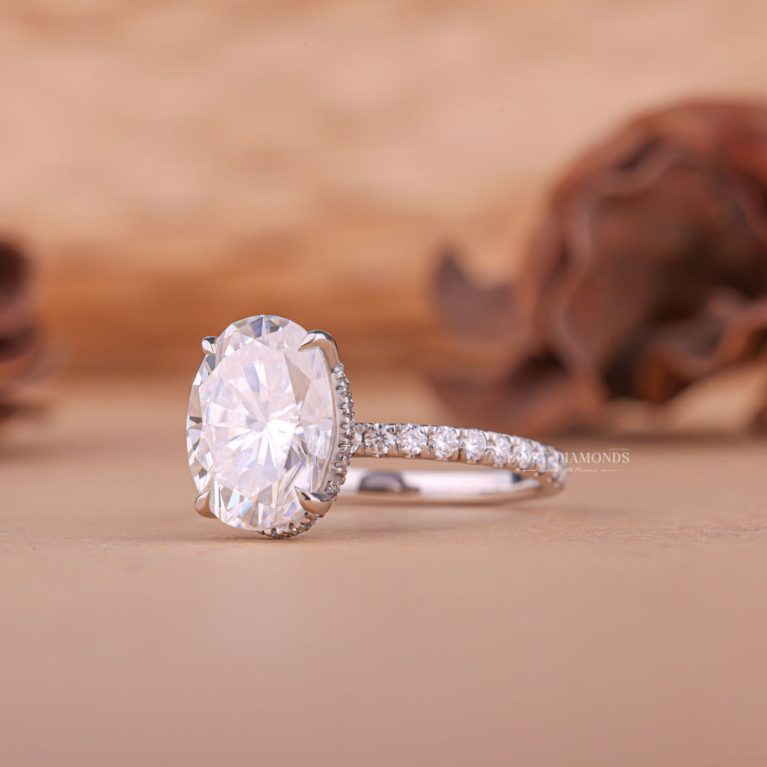 Oval hidden halo engagement ring finished in polished solid gold