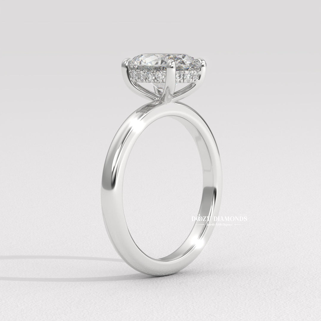 Oval hidden halo engagement ring shown on hand for true-to-life sizing