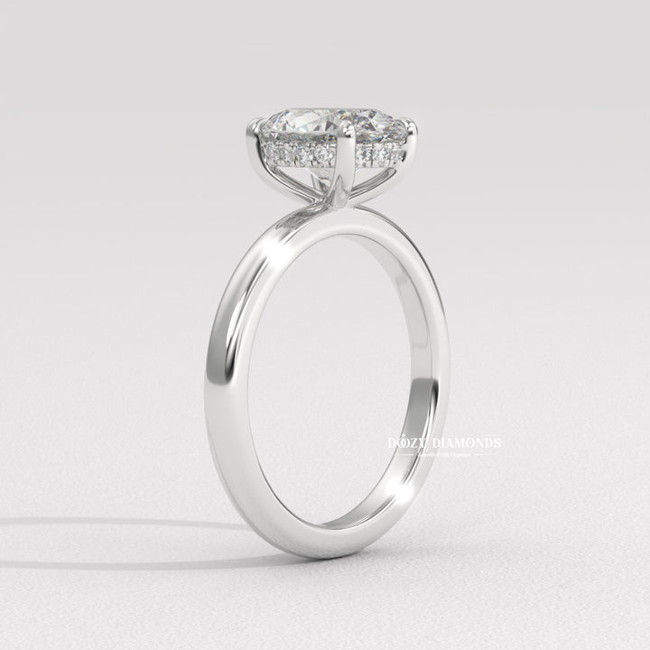 Oval hidden halo engagement ring shown on hand for true-to-life sizing