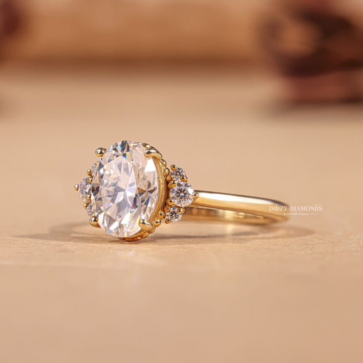 Oval cluster engagement ring shown on hand for true-to-life sizing