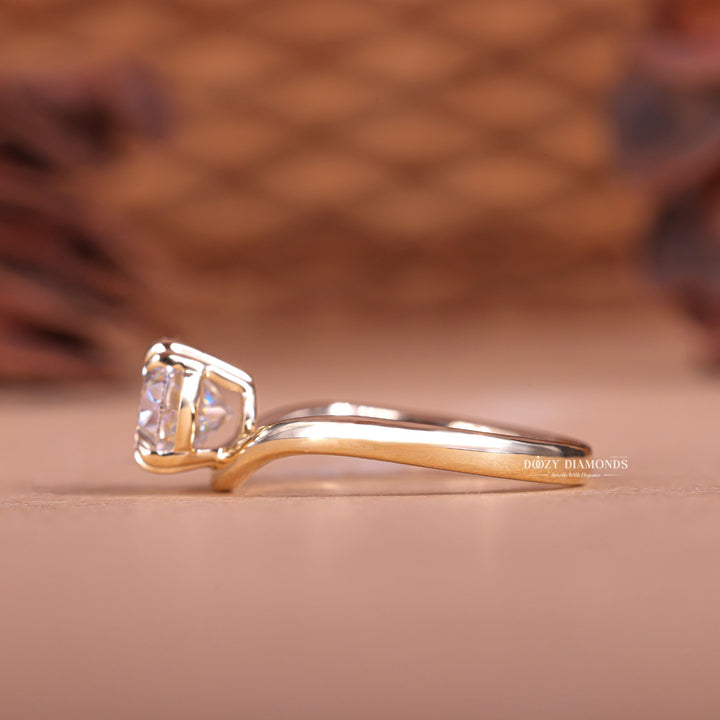 Angled view of oval cut diamond in east west setting