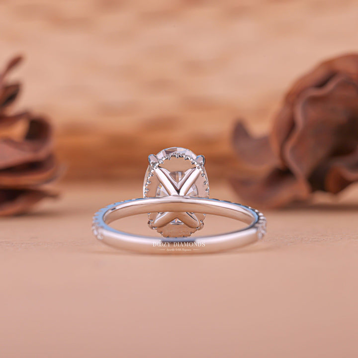 Fine craftsmanship detail on oval hidden halo engagement ring