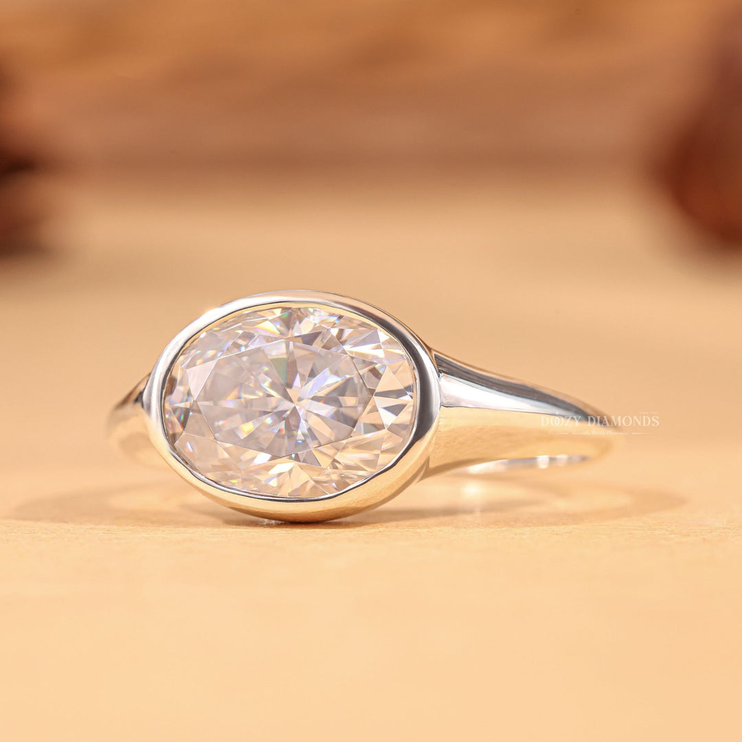 Oval east west engagement ring shown on hand for true-to-life sizing