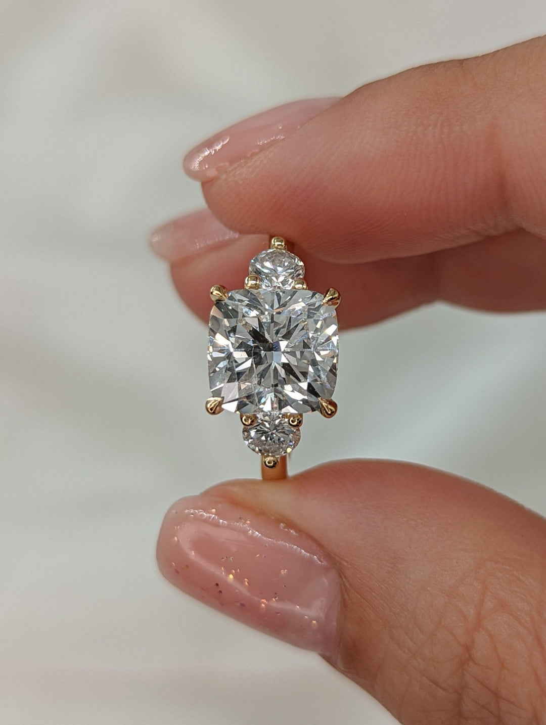Macro shot of cushion cut diamond facets in solitaire ring setting