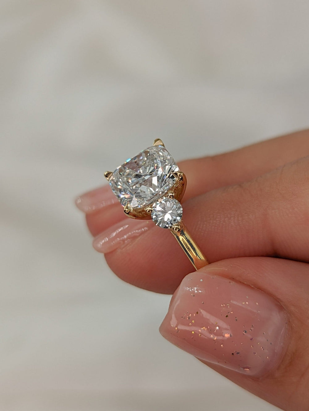 Cushion solitaire engagement ring close-up highlighting diamond sparkle
