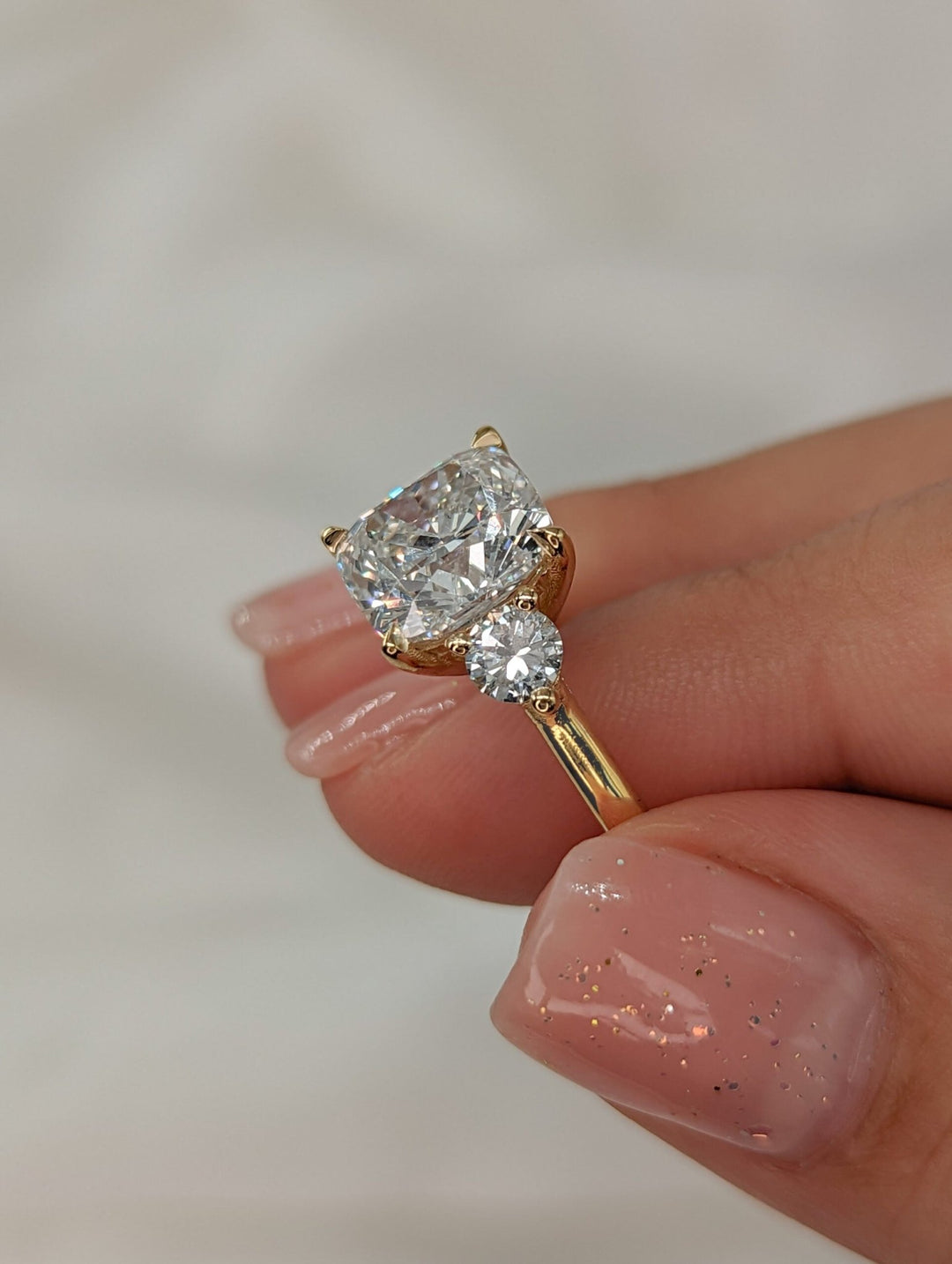 Cushion solitaire engagement ring close-up highlighting diamond sparkle