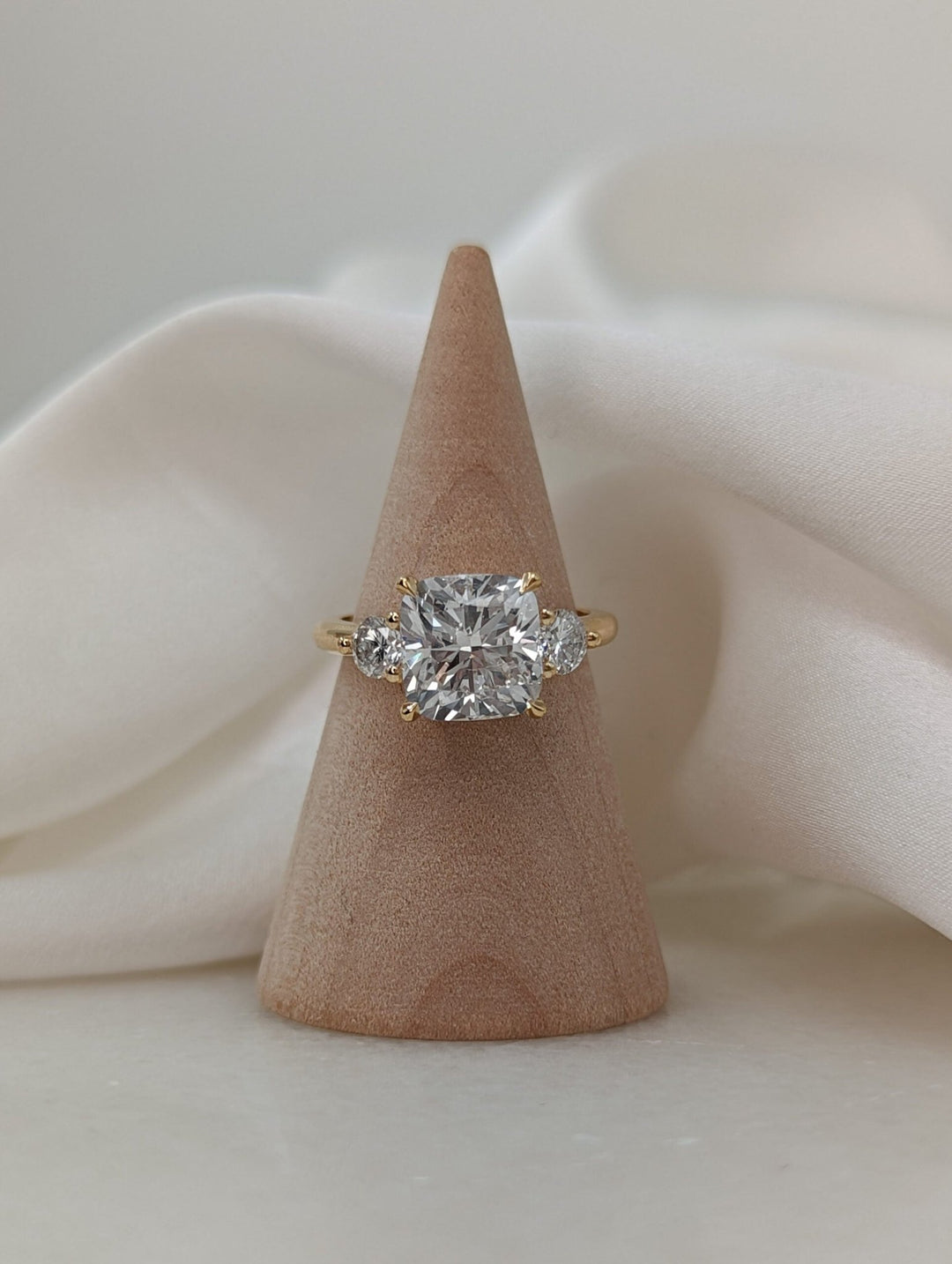 Detailed close-up of cushion solitaire diamond engagement ring