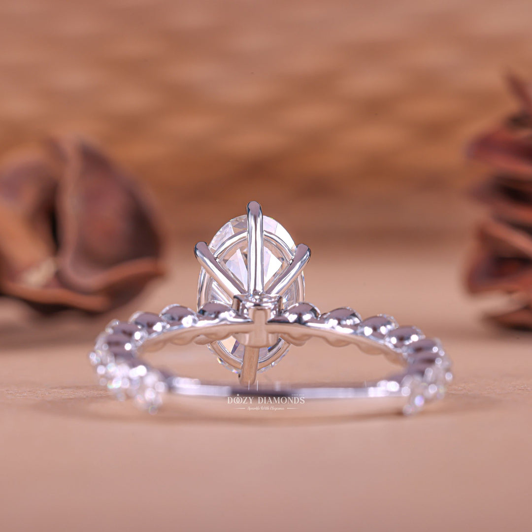 Detailed close-up of oval pave diamond engagement ring