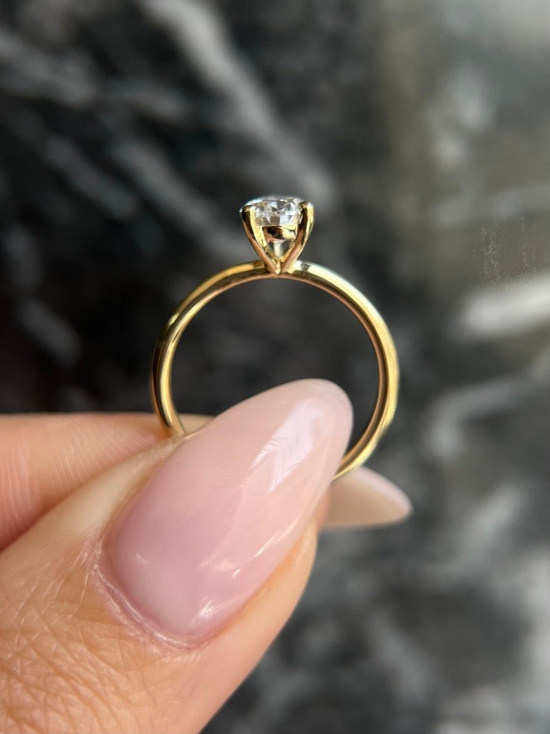 Pear solitaire diamond ring displayed on jewelry stand