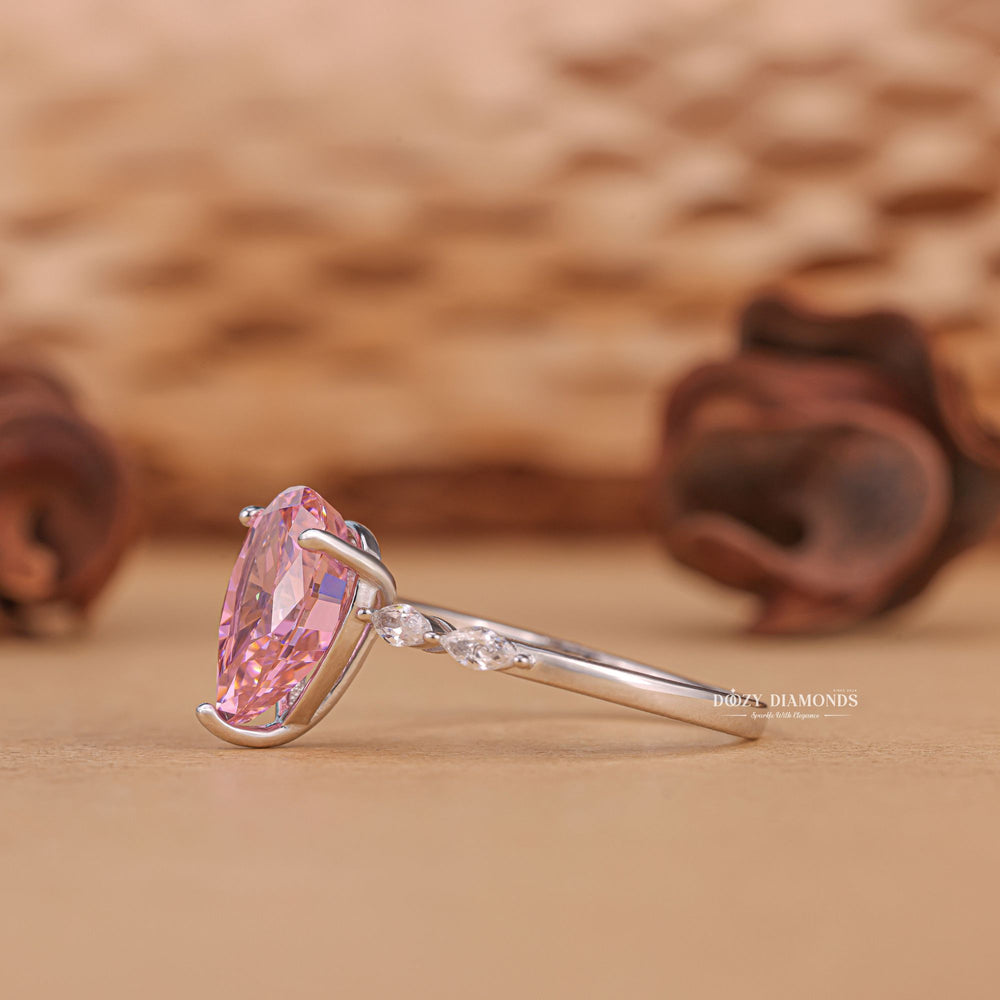 Close-up of pear cut center diamond in pave engagement ring