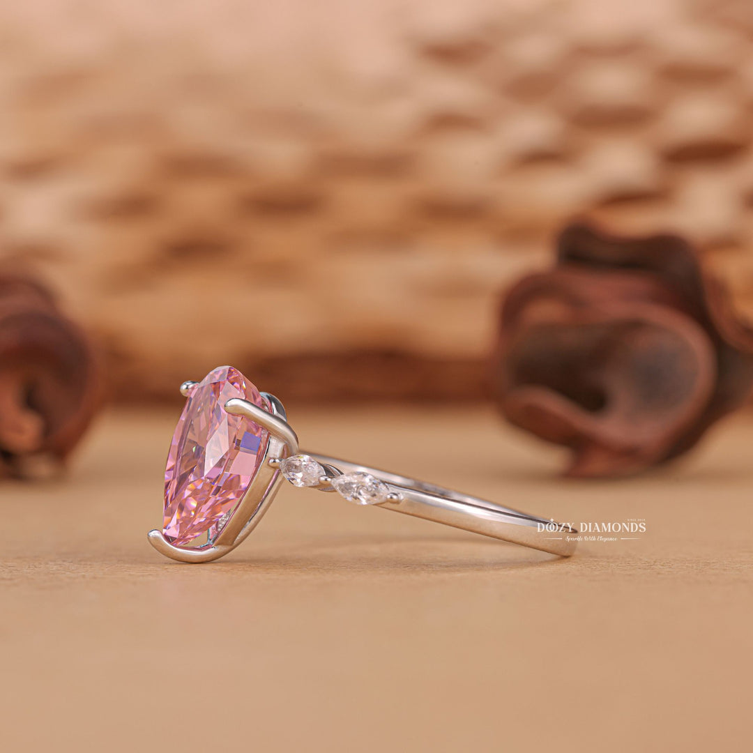 Close-up of pear cut center diamond in pave engagement ring