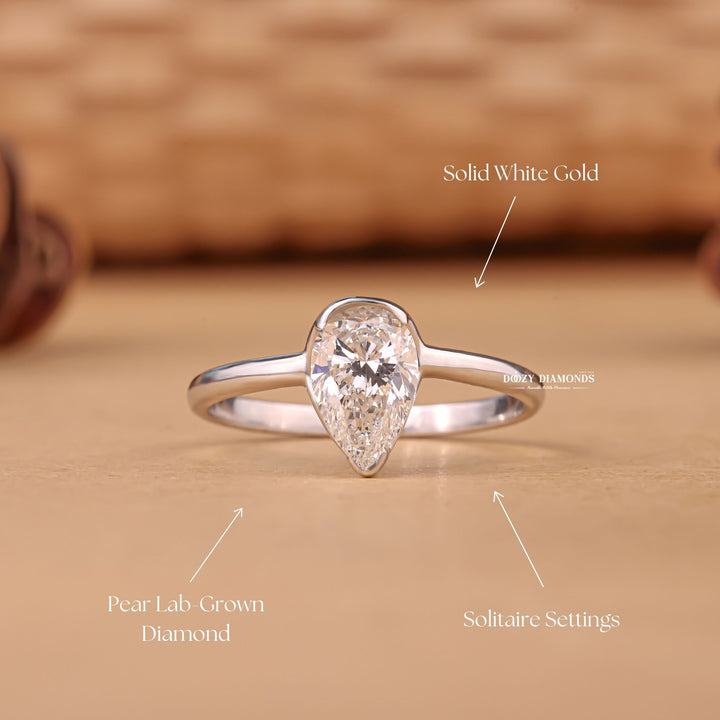 Pear cut engagement ring shown with authenticity certificate