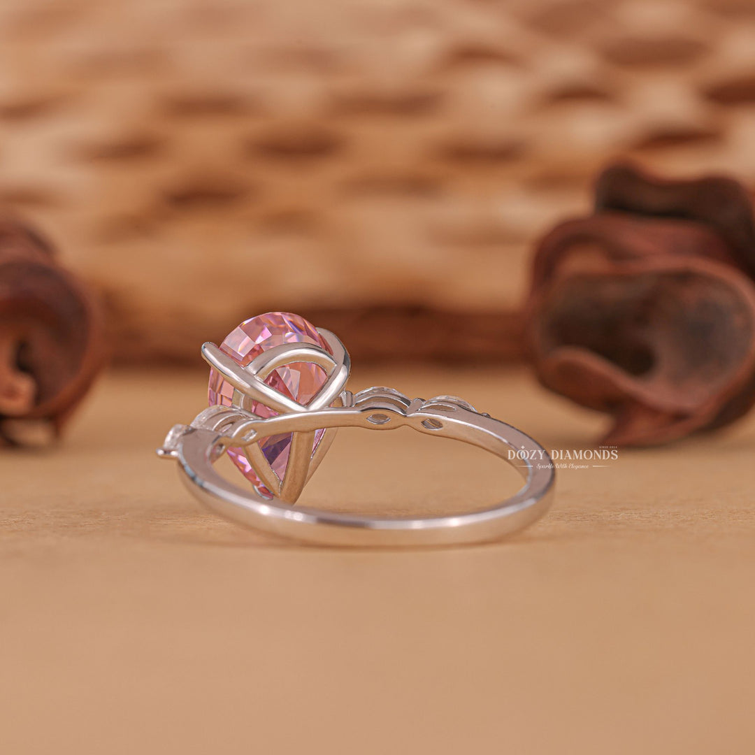 Macro shot of pear cut diamond facets in pave ring setting