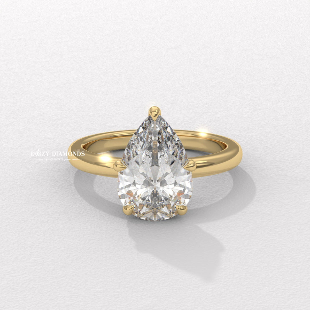 Pear cut hidden halo engagement ring available to buy now
