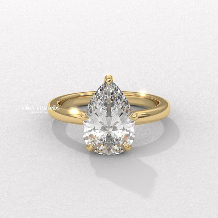Pear cut hidden halo engagement ring available to buy now
