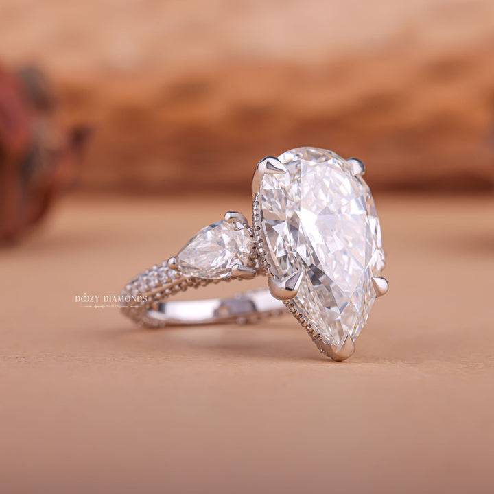 Premium pear cut three stone engagement ring crafted in solid gold