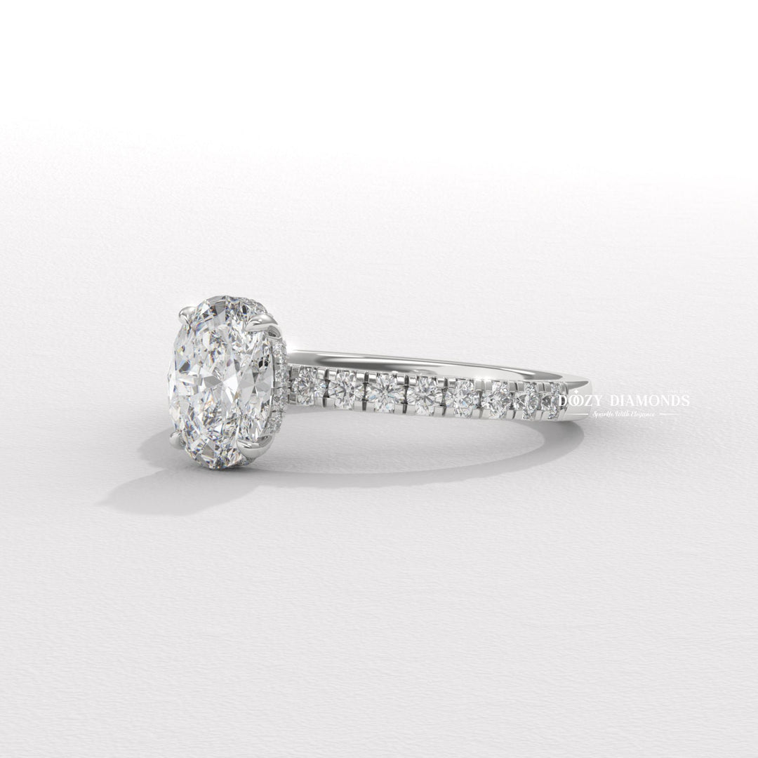 Oval hidden halo diamond ring displayed on jewelry stand