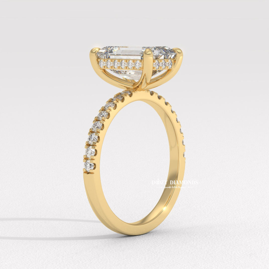Close-up of emerald cut center diamond in hidden halo engagement ring