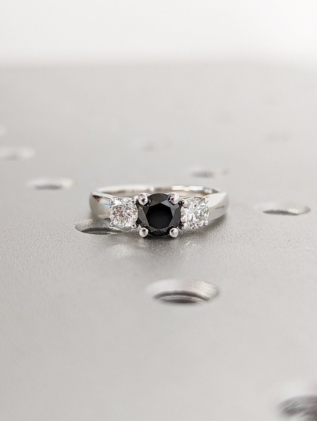 Lifestyle shot of round solitaire diamond ring on hand