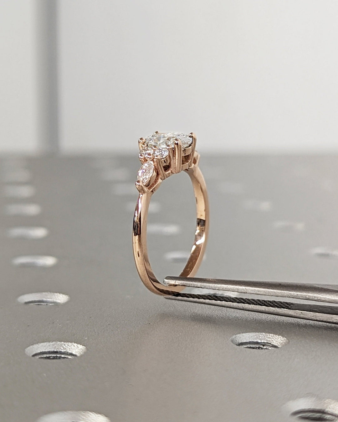 Lifestyle shot of oval cluster diamond ring on hand