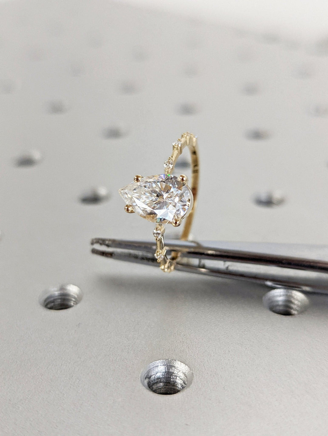 Pear cut diamond ring worn on hand