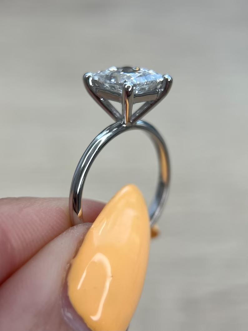 Princess solitaire engagement ring finished in polished solid gold