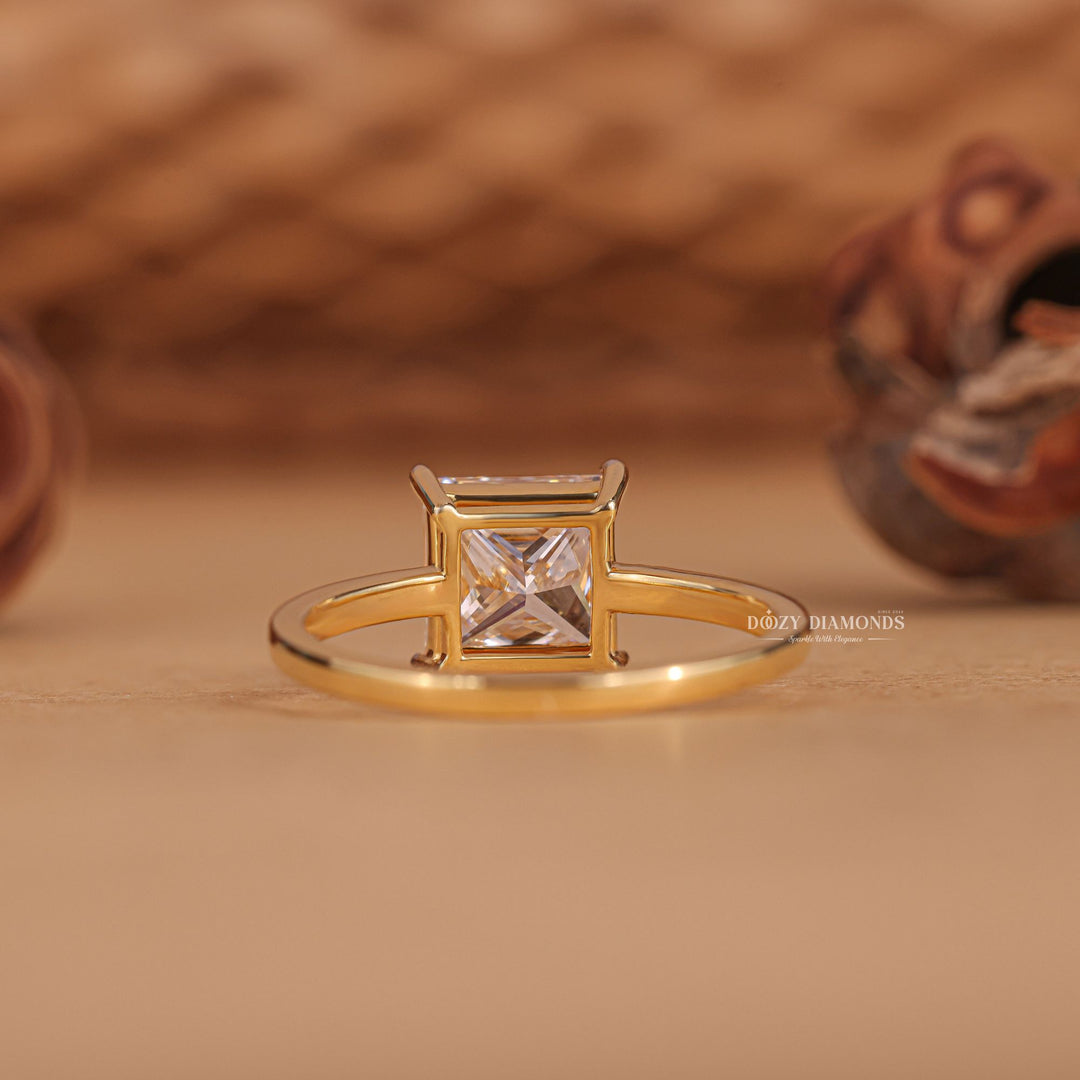 Princess solitaire diamond ring displayed on jewelry stand
