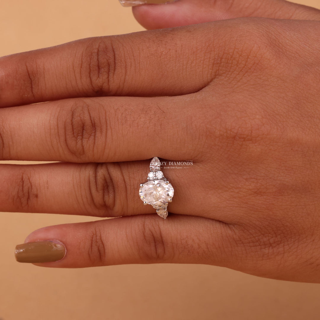 Oval cut cluster engagement ring shown in real-life wear