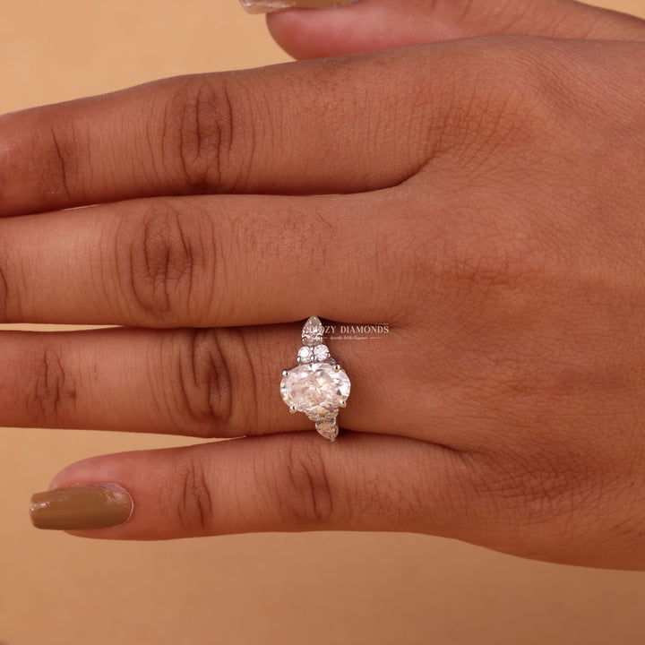 Oval cut cluster engagement ring shown in real-life wear